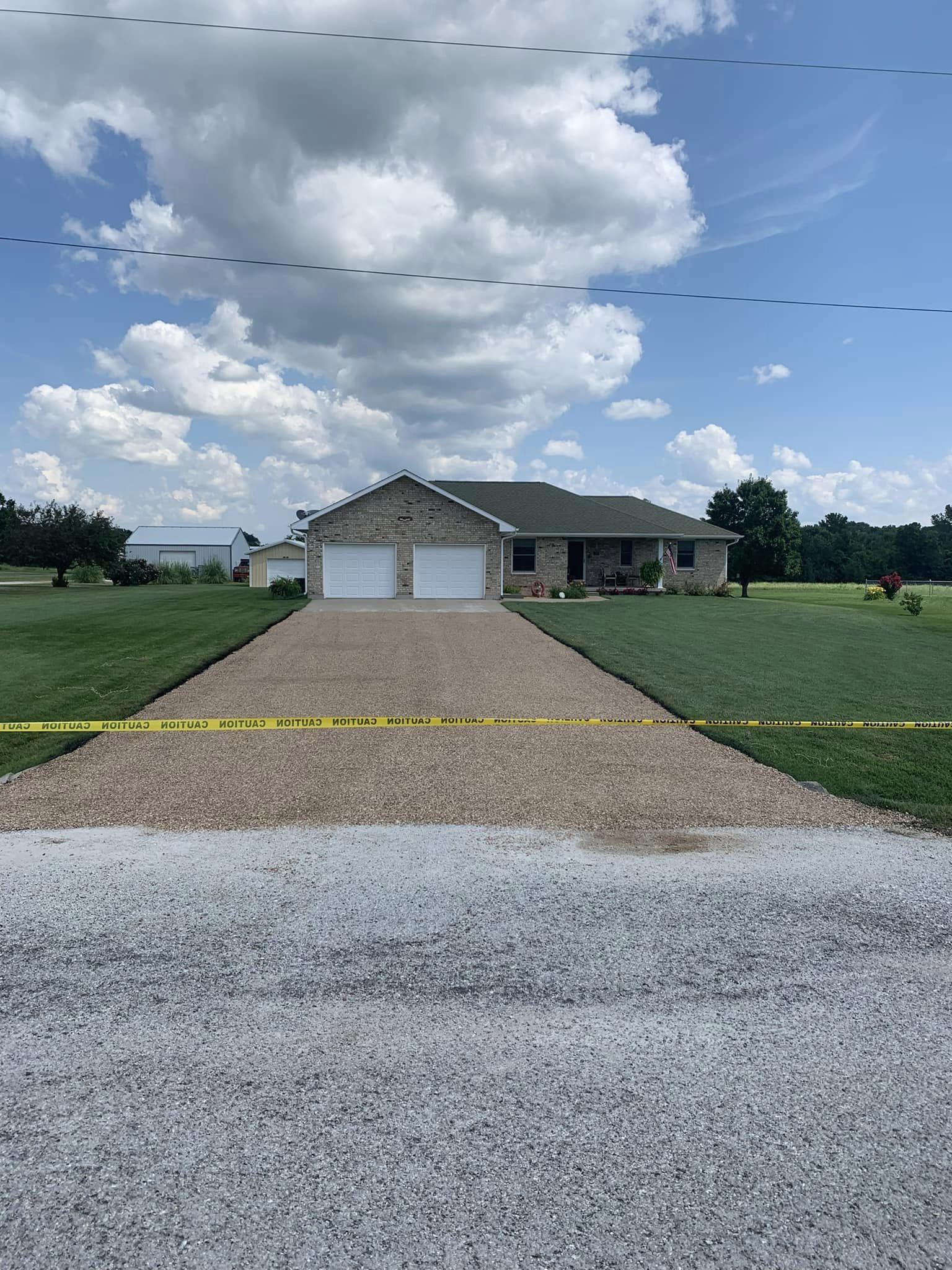 Tar and chip paved driveway leading up to a property — a Bold North specialty for rural Minnesota and Wisconsin